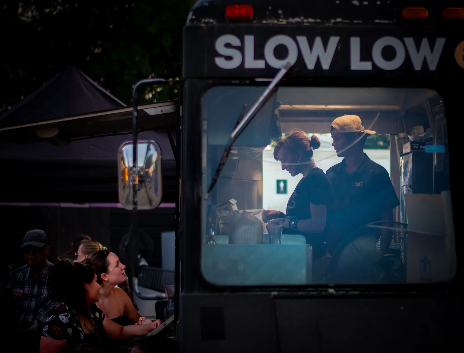 Customers at an Austin food truck at night